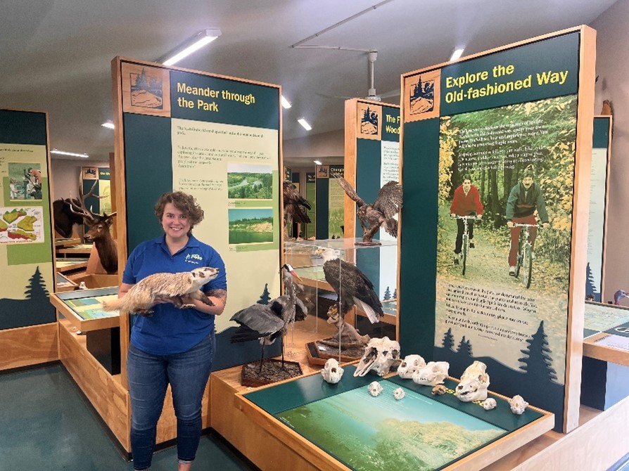 Park Interpreter holding a stuffed Weasel